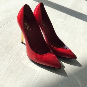 Red YSL pumps with gold accents
